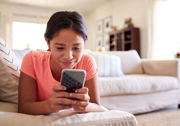 Young girl on phone at home