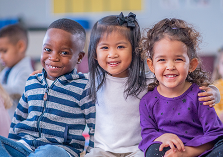 Three children smiling