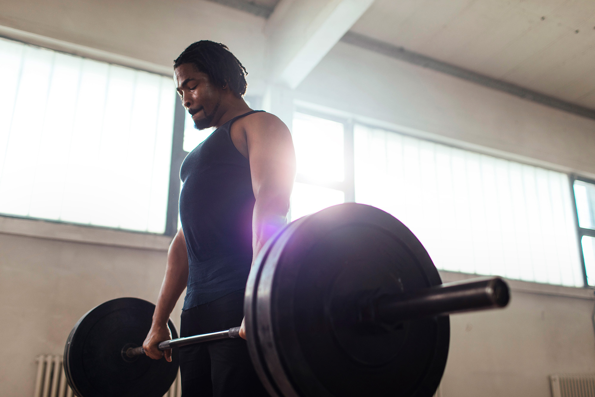 Young Fit Man Lifting Weights