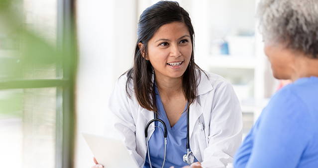 Doctor explaining patient's paperwork on a tablet